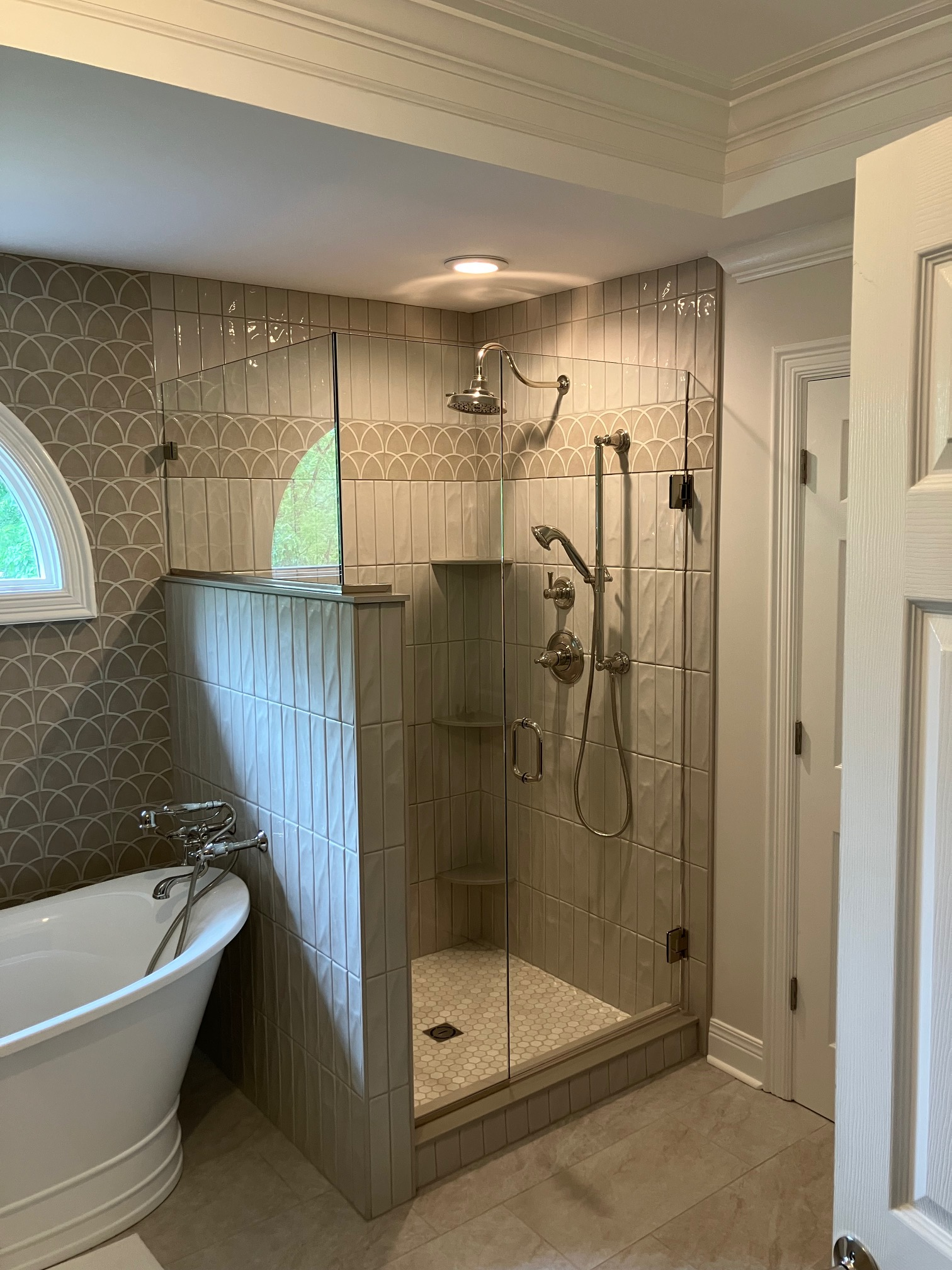 Custom clamp-anchored glass shower installation with channel support