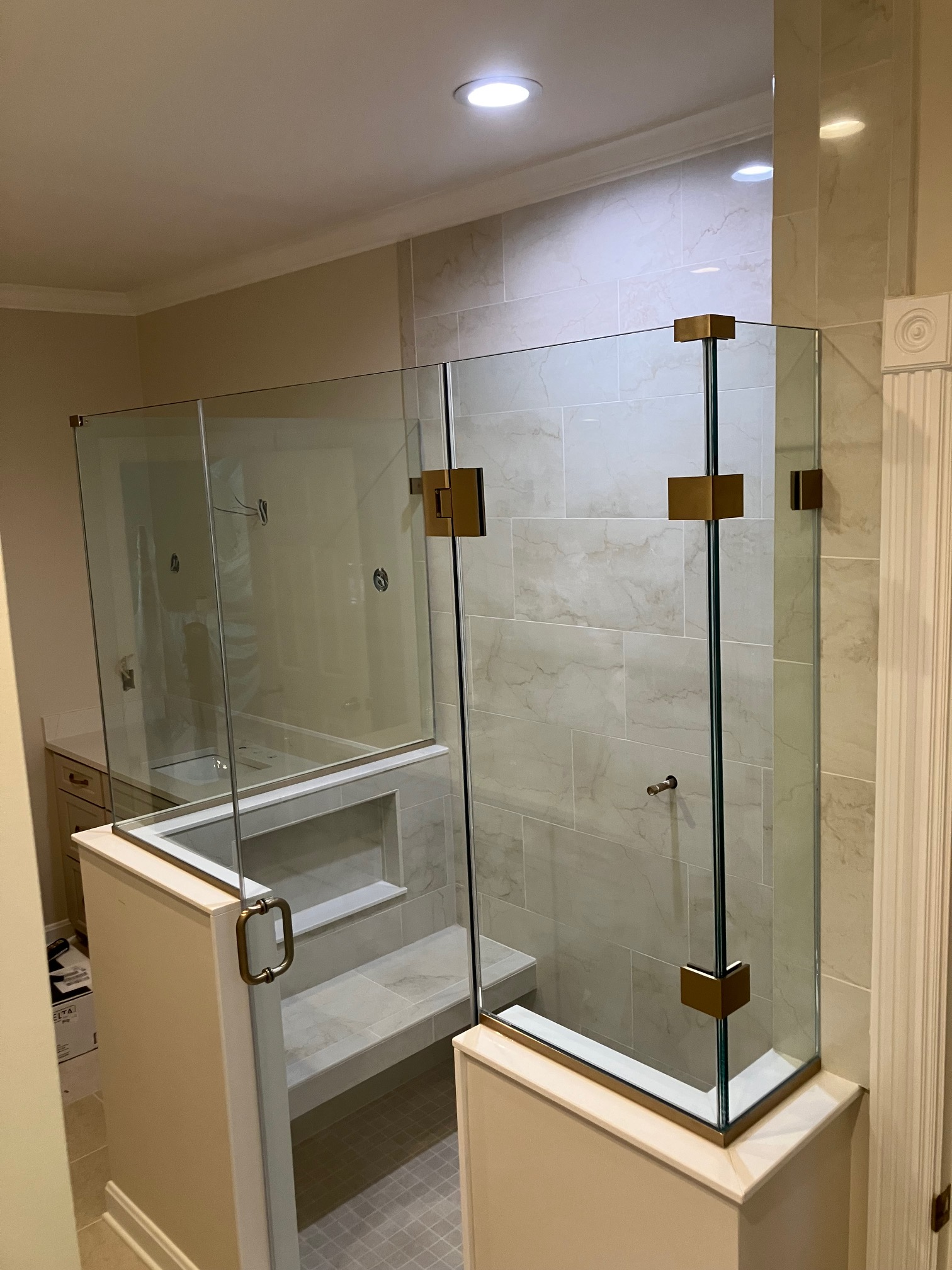 Channel and clamp glass shower installation with precision wall brackets