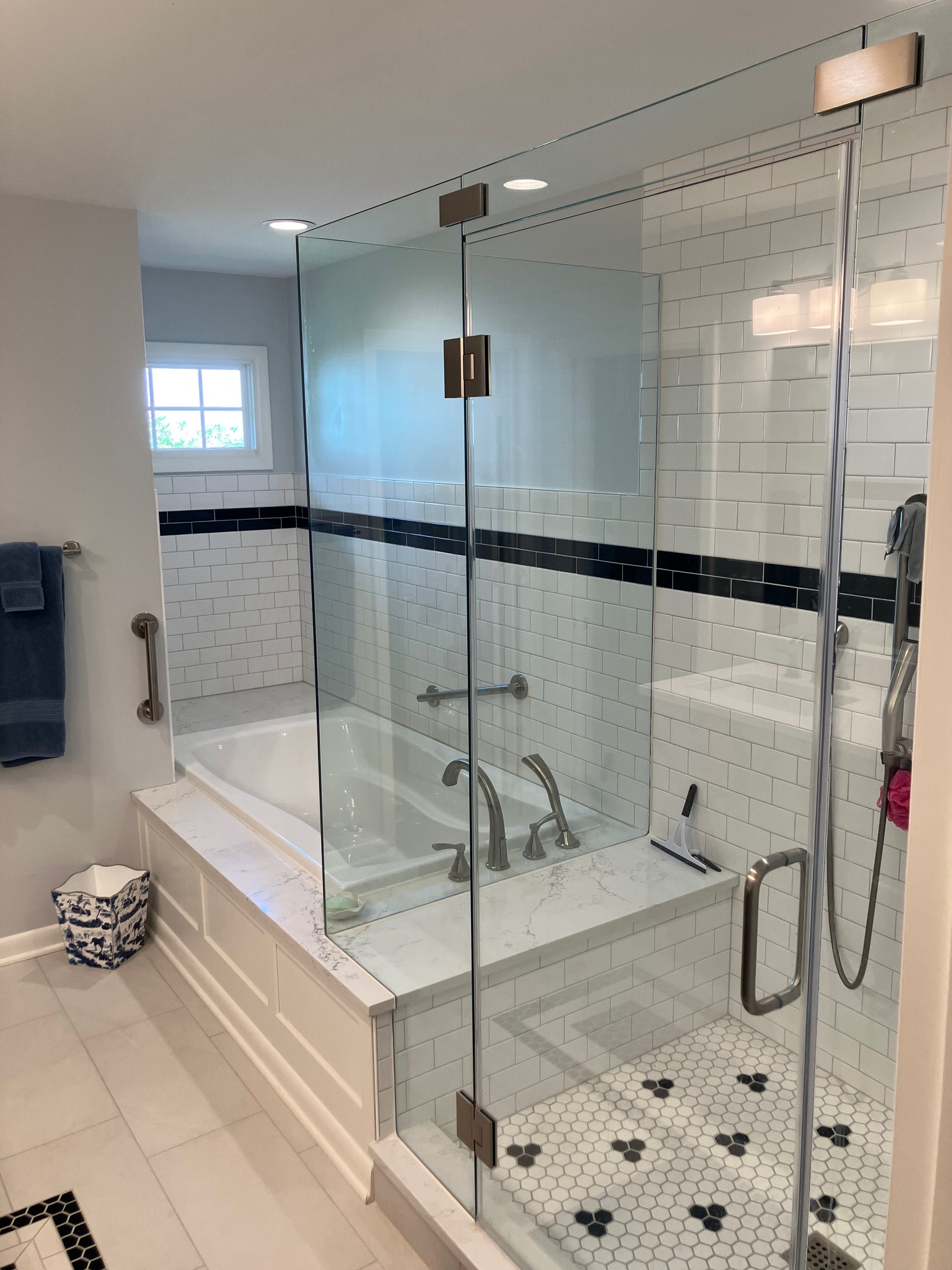Tile cut-in frameless tub and shower enclosure with seamless channel fit