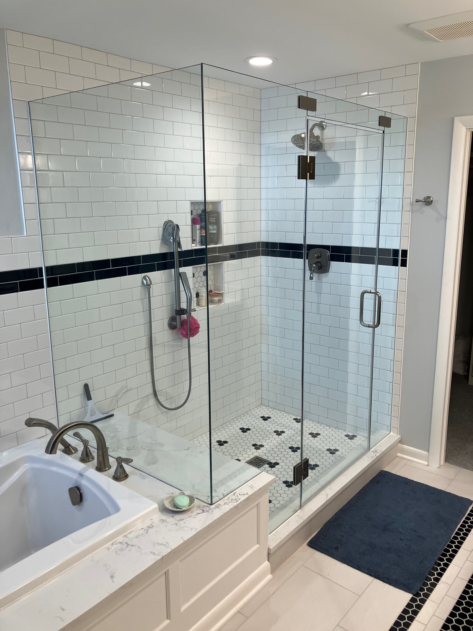 Tile cut-in frameless shower enclosure with clean subway tile integration