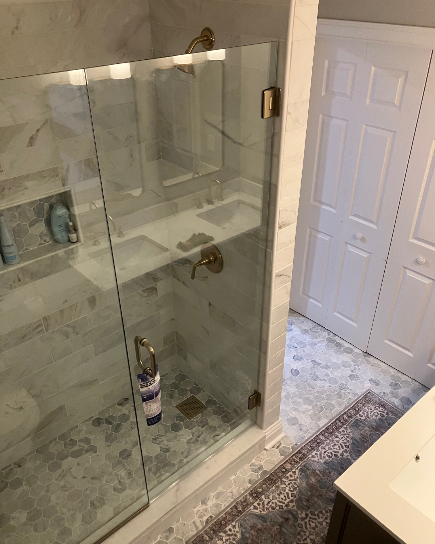 Heavy channel hardware and clamp mounted frameless shower door assembly